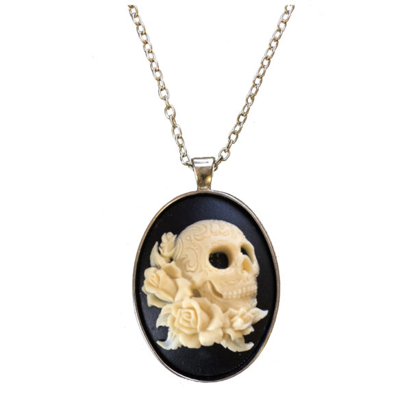 Jewelry Halloween ivory color skull with roses on a black background in a simple silver setting. The chain is 24″ with a lobster clasp.