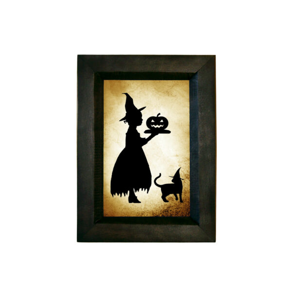 Silhouettes Halloween Girl Witch Serving Pumpkin Printed Paper Silhouette Behind Glass in Black Wood frame. 5-1/2″ x 7-1/2″