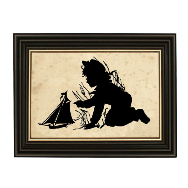 Silhouettes Nautical Pond Play Boy with Toy Sailboat Framed Paper Cut Silhouette in Black Wood Frame with Gold Trim. An 6-3/4 x 10″ framed to 8-3/4 x 12″.