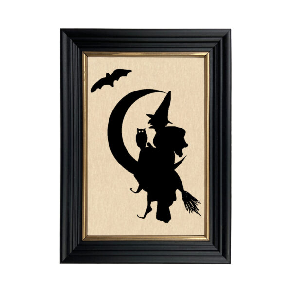 Framed Silhouette Halloween Witch Over Moon Framed Paper Cut Silhouette in Black Wood Frame with Gold Trim. An 6-3/4 x 10″ framed to 8-3/4 x 12″.