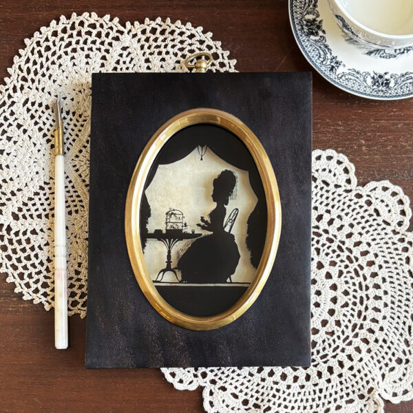 Early American Victorian 8-1/2″ Lady Feeding Caged Bird Reverse Printed Silhouette